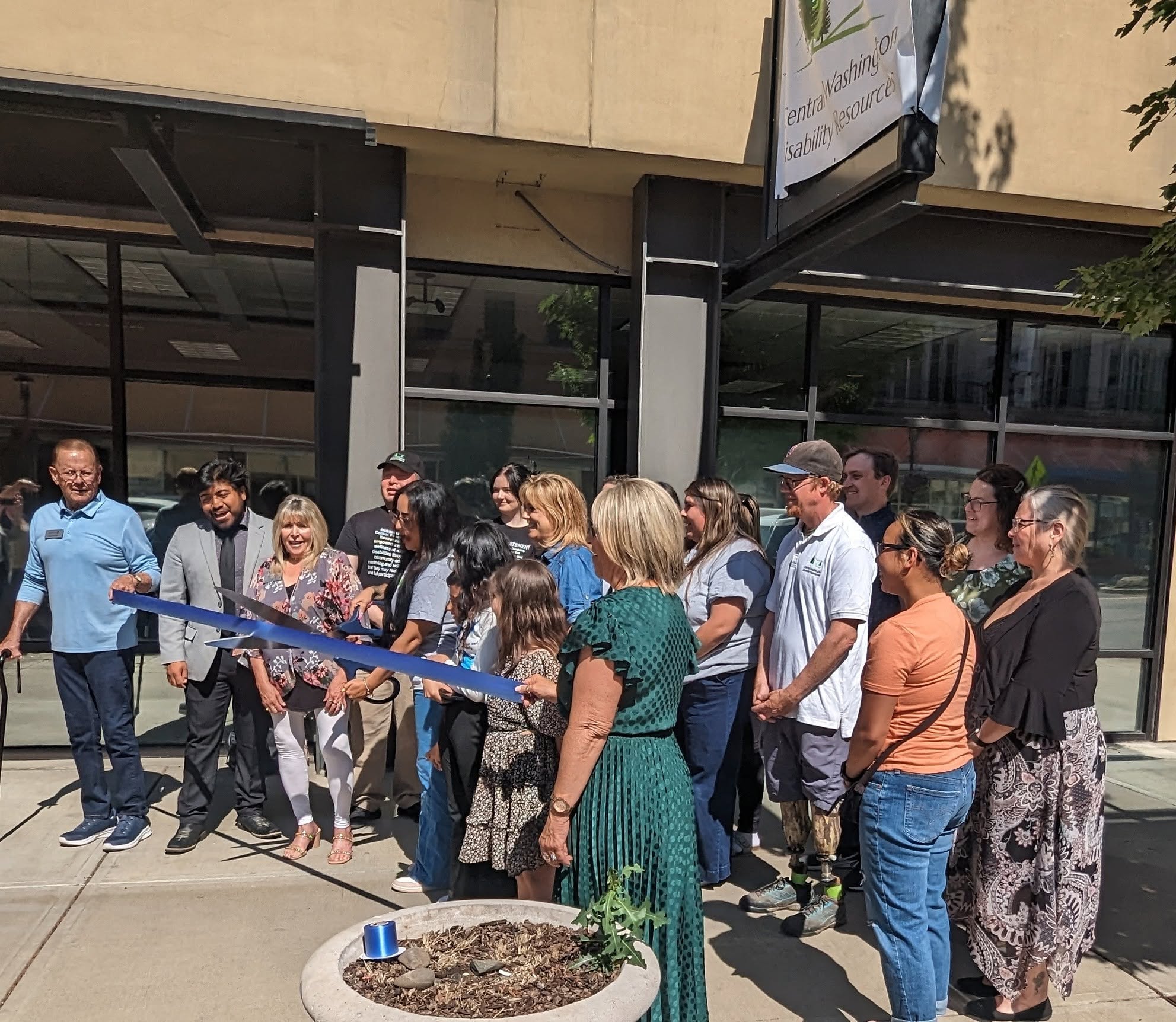 Nonprofit leaders and community members celebrating a ribbon cutting in the Pacific Northwest